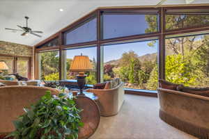 Living room featuring, high vaulted ceiling, ceiling fan, and view of Pine Valley Mountains