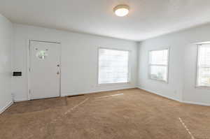 Foyer featuring carpet floors