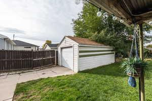 Garage featuring a lawn