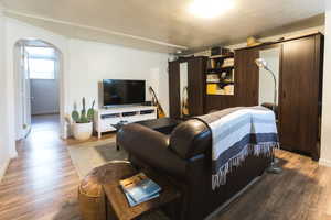 Living room featuring hardwood / wood-style floors and a textured ceiling