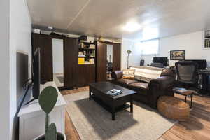 Living room featuring light hardwood / wood-style floors and a textured ceiling