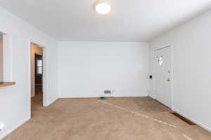 Spare room with light colored carpet