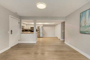 Unfurnished living room with light hardwood / wood-style flooring