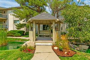 View of home's community with a gazebo and a lawn