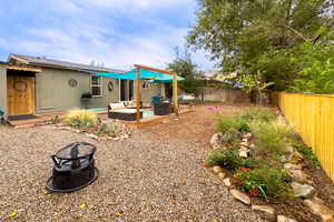 View of yard featuring a patio and an outdoor living space with a fire pit