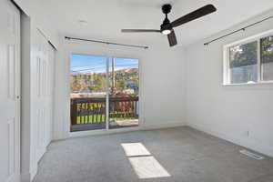 Spare room with light carpet and ceiling fan