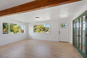 Foyer with light hardwood / wood-style floors and a textured ceiling