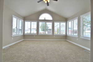 Sunroom featuring ceiling fan and lofted ceiling