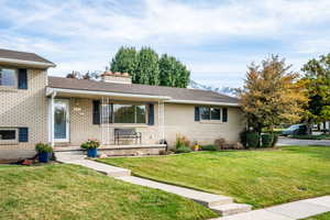 Split level home with a mountain view and a front lawn