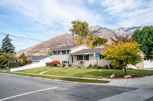 Split level home with a mountain view and a front yard