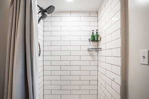 Bathroom featuring a shower with shower curtain