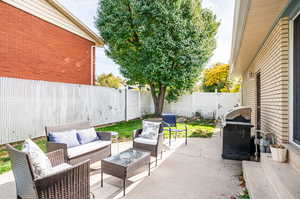 View of patio with grilling area and an outdoor hangout area