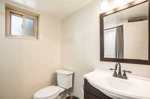 Bathroom featuring vanity, a shower with curtain, and toilet