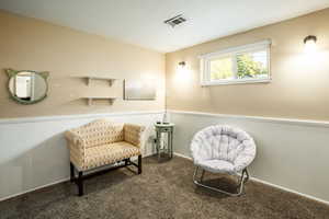 Sitting room featuring carpet flooring