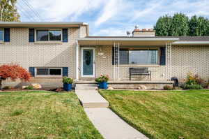 Split level home with a front lawn