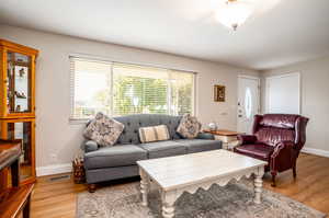 Living room with light hardwood / wood-style flooring