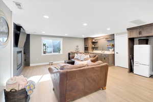 Living room with sink and light hardwood / wood-style flooring