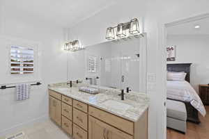 Bathroom featuring vanity, an enclosed shower, and lofted ceiling