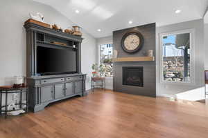 Living room featuring lofted ceiling and hardwood / wood-style flooring