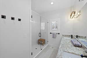 Bathroom featuring an enclosed shower and vanity