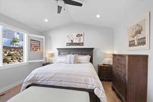 Bedroom featuring ceiling fan, vaulted ceiling, and light hardwood / wood-style floors