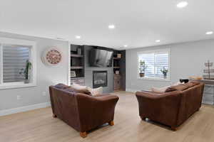 Living room featuring a fireplace and light wood-type flooring