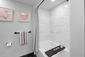 Bathroom with shower / bath combo with shower curtain