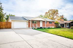 Single story home with a front lawn and a garage