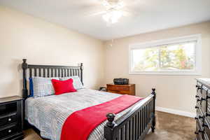 Carpeted bedroom with ceiling fan