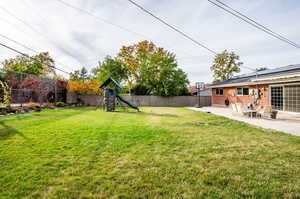 View of yard featuring a patio and a playground