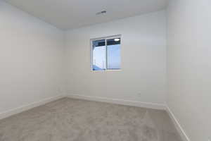 Unfurnished room with light colored carpet