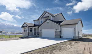 View of front of house featuring a mountain view and a garage