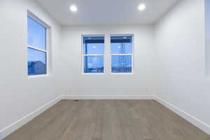 Empty room with hardwood / wood-style flooring