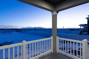 Snow covered deck with a mountain view