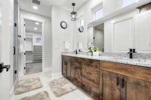 Bathroom featuring vanity, tile patterned floors, and a shower with shower door