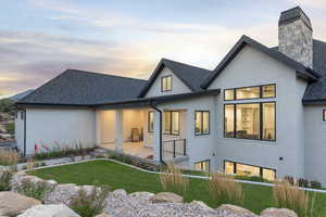 View of front of property with a patio and a lawn