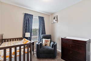 Secondary bedroom with carpet flooring and closet.