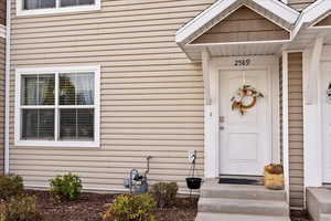 Large windows, covered entry with concrete access.