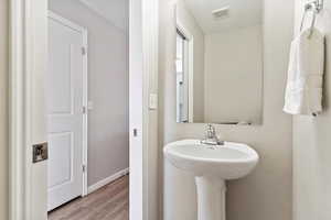 Main floor half bath with pedestal sink.