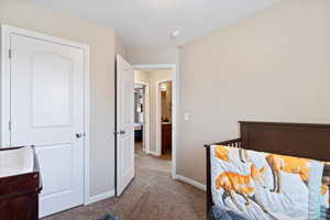 Secondary bedroom with carpet flooring and closet.