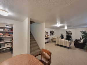 Living room with a textured ceiling and carpet floors