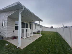 View of yard with central air condition unit and a patio area