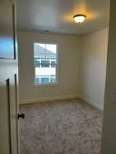 Unfurnished room with carpet floors