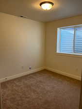 Spare room featuring carpet flooring