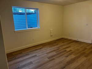 Unfurnished room with hardwood / wood-style floors