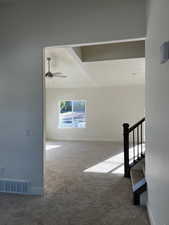 Stairs featuring carpet flooring and ceiling fan