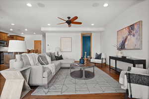 Living room featuring hardwood / wood-style flooring and ceiling fan