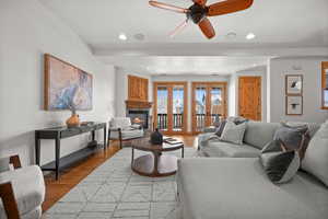 Living room featuring ceiling fan and light hardwood / wood-style flooring