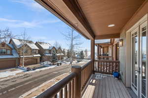 View of snow covered back of property