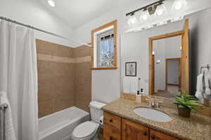 Full bathroom with vanity, toilet, and shower / tub combo